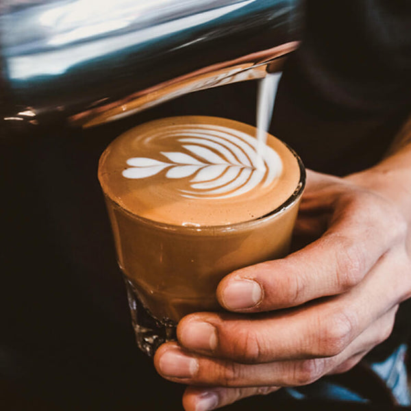 Close-up of espresso drink with pattern of steamed milk on top